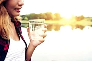 Young Beautiful Hipster Woman Holding Water Standing On